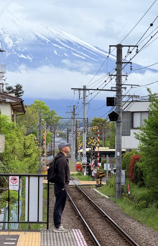 Jerry at a railway crossing in Fujiyoshida, with Mount Fuji in the background